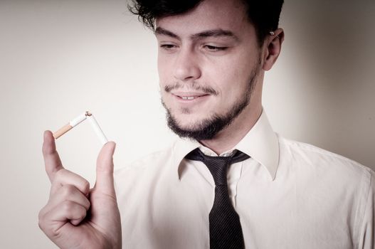businessman stop smoking on gray background