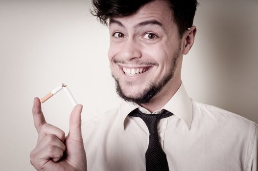 businessman stop smoking on gray background