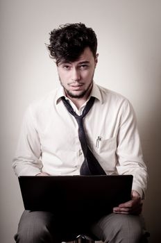 stressed businessman using notebook on gray background