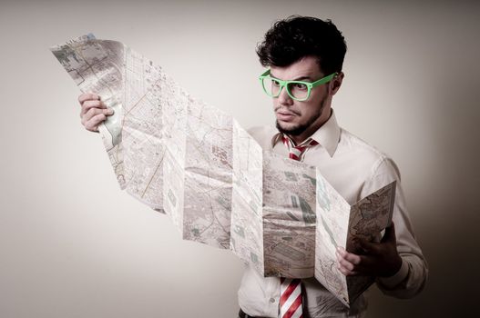 lost businessman with map on gray background