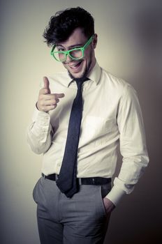 sexy stylish businessman with green eyeglasses on gray background