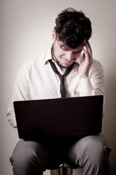 stressed businessman using notebook on gray background