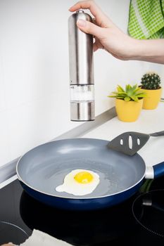Woman salt egg in a frying pan