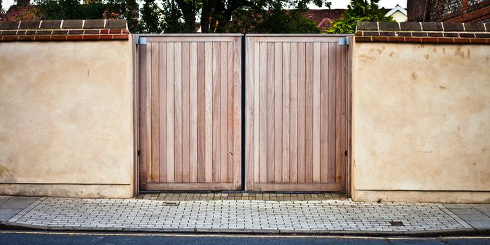 New wooden gate in a stone wall