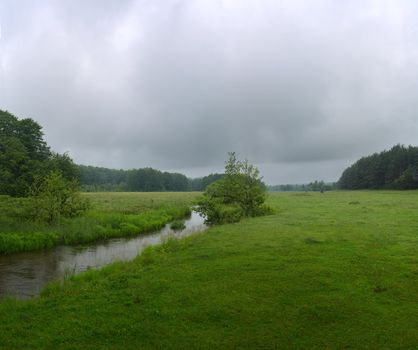 Green River flowing through green field on a summer morning