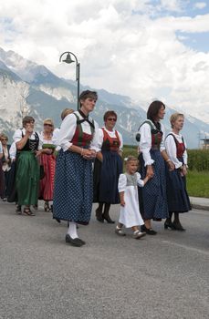 AXAMS,AUSTRIA - AUGUST 15:Unidentified peoplewalking in procession to the church on Maria Ascension,on August 15, 2012 in Axams, Austria. Maria Ascension is the annual christian celebration in Axam