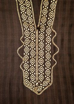 Close up of embroidered neck line on a black moroccan men's robe