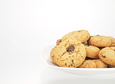 bowl of chocolate chip cookies on white background