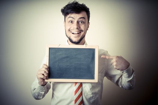 businessman with a blank blackboard on gray background