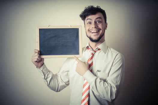 businessman with a blank blackboard on gray background