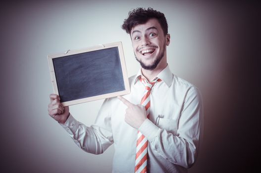 businessman with a blank blackboard on gray background