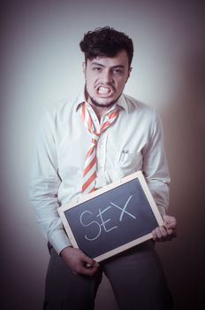 businessman with a blank blackboard write sex on gray background