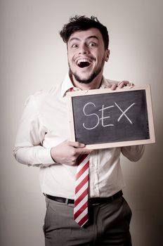 businessman with a blank blackboard write sex on gray background