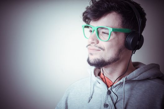 boy with sweatshirt and headphones on gray background 