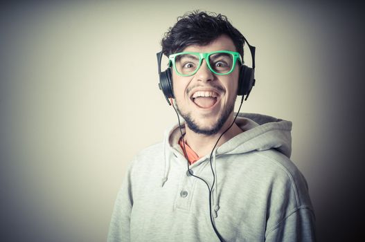 boy with sweatshirt and headphones on gray background 