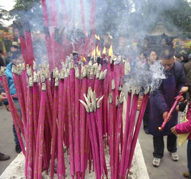 CHENGDU - FEB 5: People burning incense upon the incense altar in temple during chinese new year on Feb 5, 2011 in Chengdu, China.Many people want to relieve their worries and difficulties by burning incense and praying to Buddha during festivals.It's part of the important traditional custom in China.