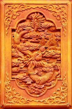 Dragon design on the wooden door of Chinese temple