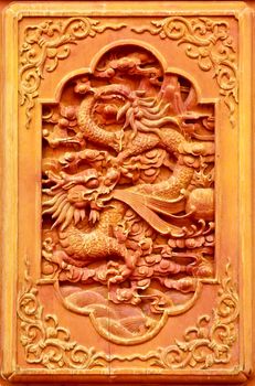 Dragon design on the wooden door of Chinese temple