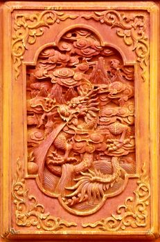 Dragon design on the wooden door of Chinese temple