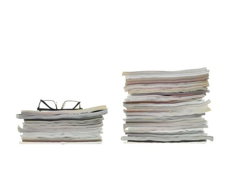 A stack of magazines isolated against a white background