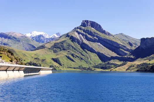 alpine landscape with lake and dam in France