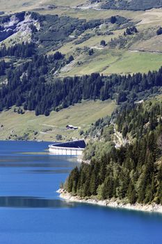 alpine landscape with lake and dam