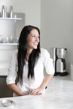 Attractive young woman in her elegant kitchen