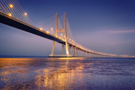 sunrise on Vasco da Gama bridge in Lisbon, Portugal 