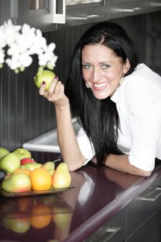 Attractive young woman eating an apple.