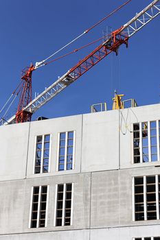 Construction site with crane and building in blue sky