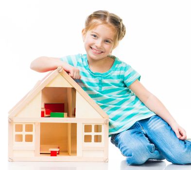 cute little girl with a toy house