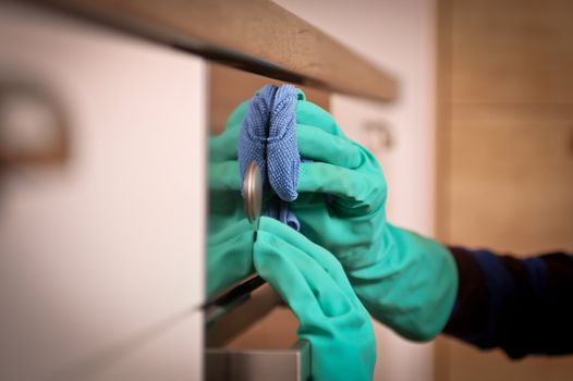 Close-up of human hands polishing the oven