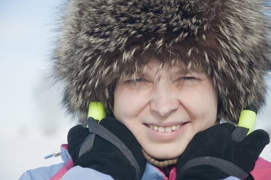 Woman tourist skier in snowy forest with ski poles