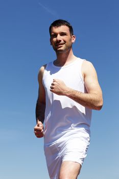 handsome man running outdoor with blue sky