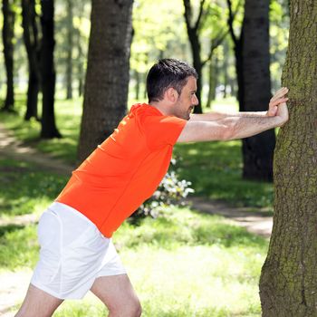 man doing exercises in a park in summer