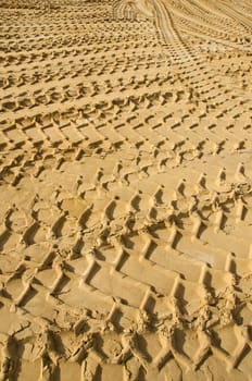 sand in industrial quarry background and texture with wheel tracks