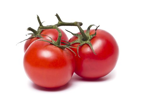 Plum tomatoes with leaves on white background