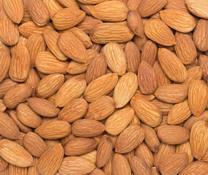 Pile of almonds close-up as background.