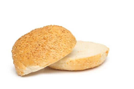 One whole bun with sesame seeds and half of the bun