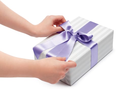 hand holding ribbon and open gift box