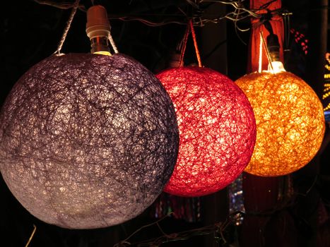 A set of beautiful designer lamps in different colors in a shop.                               