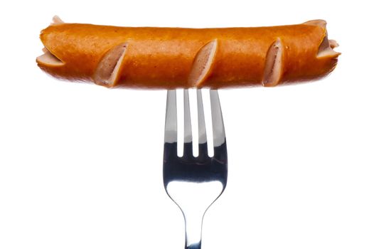 Cooking sausage on a fork on a white background