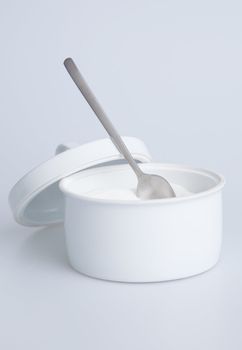 White sugar container with silver spoon