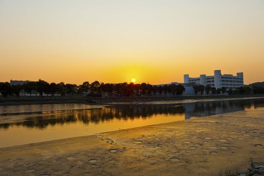 Sunset along river at factories