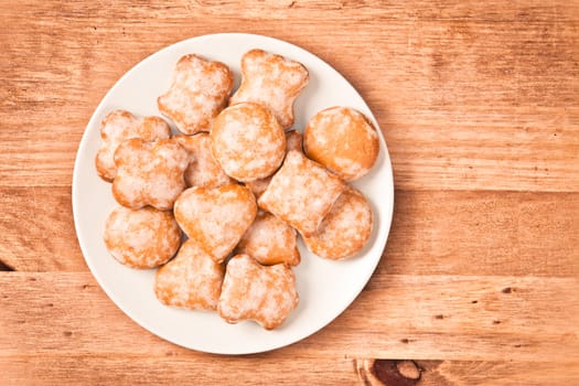 Polish ginger cookies on a plate on wooden background