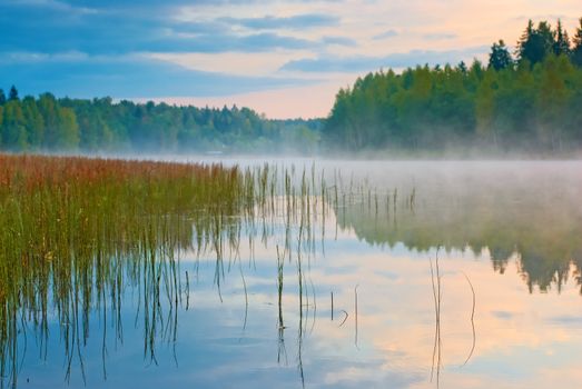 Sunrise on the lake with mist