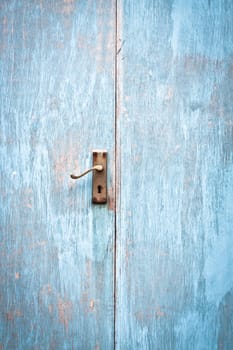 A weathered wooden blue door as a background image