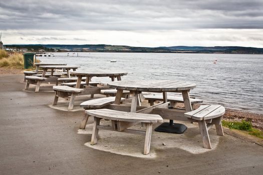 Wooden picnic tables at a seaside cafe in Findhorn, Scotland