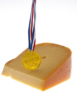 a piece of cheese with a winner's medal