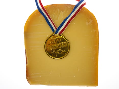 a piece of cheese with a winner's medal